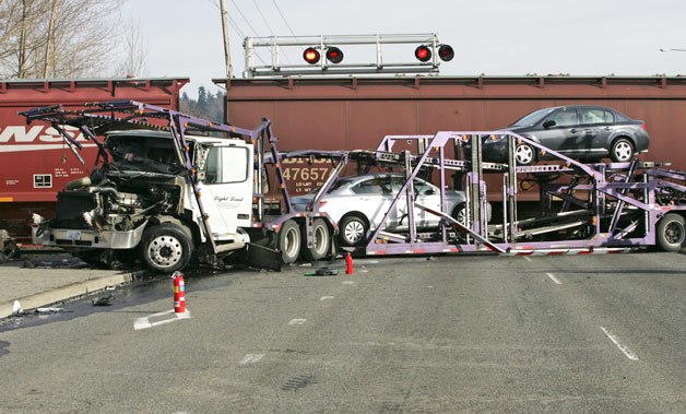 A train hit a semi truck carrying a load of new cars Friday afternoon in Kent.