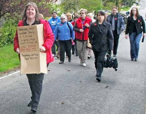 Kent teacher Sue Green holds a sign during a Kent Education Association rally May 5