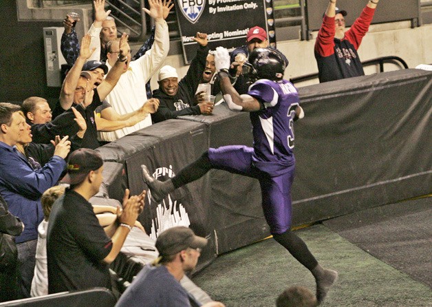 Seattle Timberwolves D.D. Holyfield leaps over the dasher boards after taking in a 17 yard pass from McClullum in for a touchdown Friday