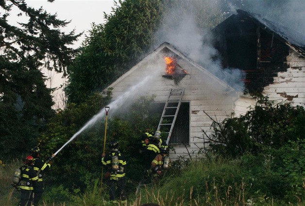 A Kent firefighters battle a blaze in the 11900 block of SE 270 Street.