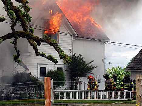 Kent firefighters work to put out a devastating blaze in the 23400 block of 116th Ave. SE on May 19.