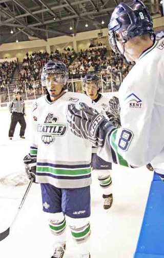 T-Bird Prab Rai gets encouragement from teammate Stefan Warg during the team's debut game Jan. 3 at the ShoWare Center of Kent. See these and a growing gallery of other T-Bird shots at our Pictopia site.