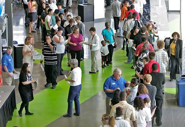 Job seekers fill the ShoWare Center concourse in July to apply for jobs at the arena. A job fair with more than 75 employers is set for 10 a.m. to 3 p.m. Tuesday