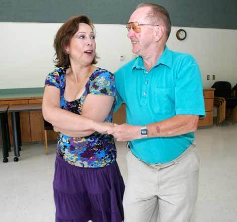 Jennifer Hanke and Orval Dealy of Kent demonstrate their dancing skills at the Kent Senior Activity Center. Hanke and Dealy are will be dance partners during the center’s first-ever Summer Ball. CHARLES CORTES
