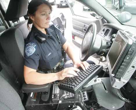 Kent Police officer Jennifer Prusa checks a database from her patrol car last month