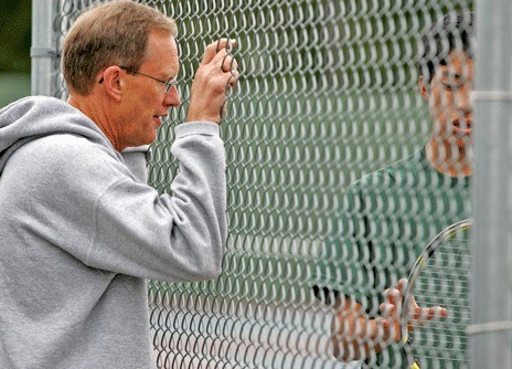 Kentridge boys tennis coach Bob Armstrong discusses strategy with No. 1 singles player Vincent Lim during a recent match.