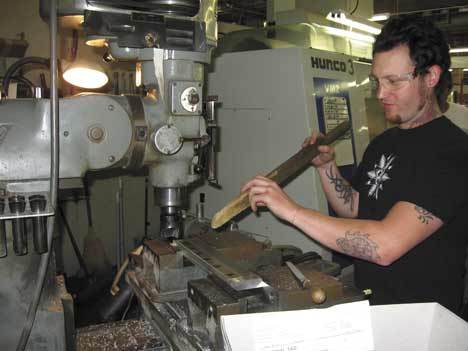 Eric Minkes of Seattle prepares to begin work on one of the machines at Orion Industries in Federal Way. Orion Industries is getting a new training program from the Kent-based Center for Advanced Manufacturing Puget Sound.