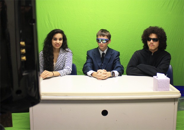 Learning by doing: Kent-Meridian tech students sit in the green screen room adjacent to Michael Christiansen’s classroom. They are filming news broadcasts and commercials as part of their history project.
