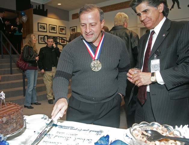 Jim Berrios and Superintendent Dr. Edward Lee Vargas cut and serve the cake during the reception to honor Jim Berrios