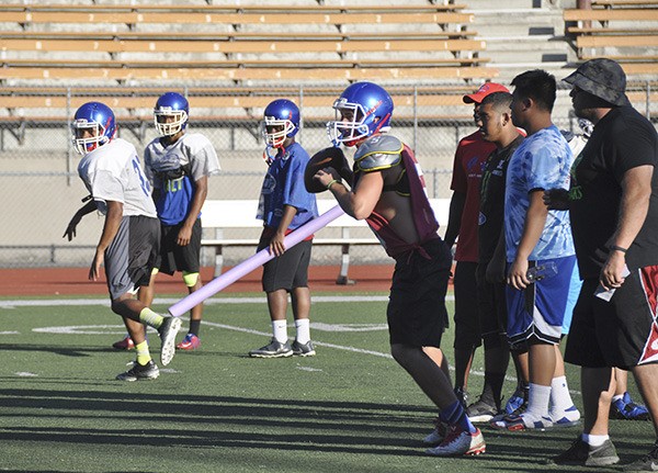 The Kent-Meridian High School football team prepares for its first game of the season. The Royals and the other Kent high schools will compete in the North Puget Sound League this year.