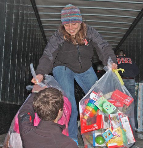 Kent firefighter Caitlin Corey delivers toys to the Kent Food Bank as part of the annual Toys for Joy drive.