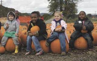 Steel Lake Christian Pre-school went last year to Carpinito Brothers pumpkin patch in Kent to pick out some pumpkins.  With the pumpkins they have chosen are (left to right) Isamu Une