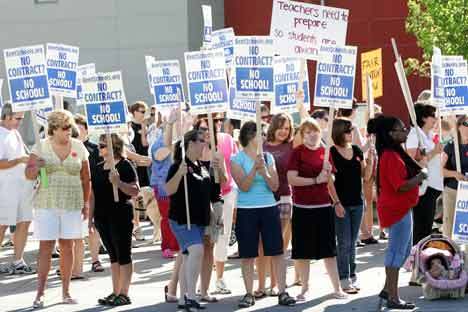 Kent Education Association members and supportes rally Wednesday before the meeting with the Kent School Board and the state mediator at Mill Creek Middle School.