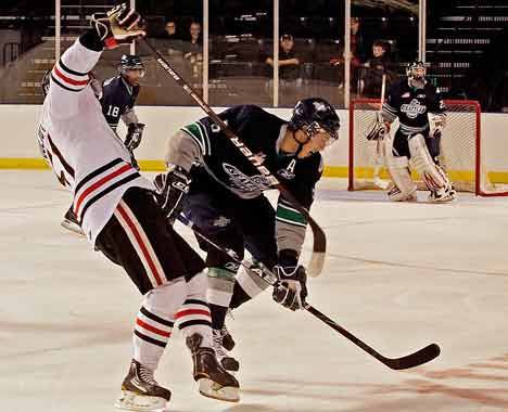 Seattle defender Brenden Dillon (5) up ends a Portland player en route to the puck