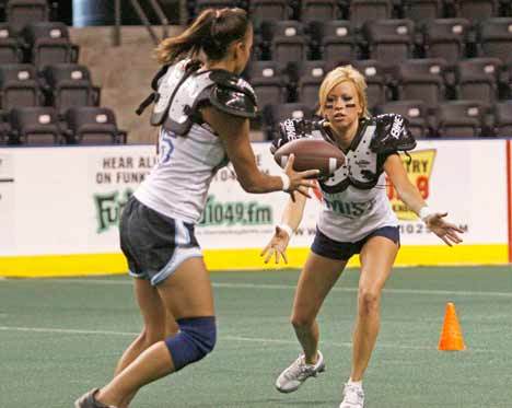 Seattle Mist Quarterback Alicia McLauchlin hands the ball off during a last practice before the scrimmage Wednesday at Kent's ShoWare Center. The scrimmage was the final test for many players trying to make the 2009/2010 Seattle Mist roster.