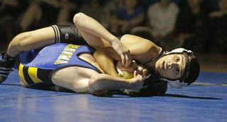 Kentwood's Ruben Navejas dominated Tahoma's Steve Hopkins in grappling action Wednesday at Tahoma High school in the 103-pound weight division.