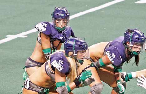 Seattle Mist's Natasha Lindsey at quarterback taking a snap in the home opener against San Diego Seduction at the ShoWare Center last year. Lindsey is slated to perform as the Mist's QB this coming season.