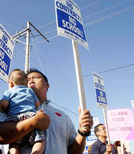 Kent School District parent Ben Ibale was out with his infant son Calvin on Wednesday during a rally in support of the Kent Education Association