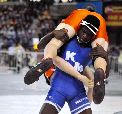 Kent-Meridian's Amos Daigbe handles Dakota Numbers of Lewis and Clark in the Mat Classic semifinals at the Tacoma Dome on Saturday. Daigbe won by major decision