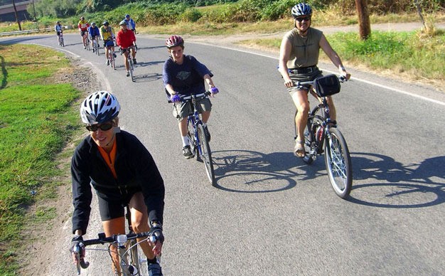 Bicyclists ride past the Green River Natural Resources Area in Kent.