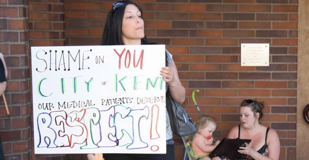 A woman opposes the Kent City Council's proposed ban on medical marijuana dispensaries and collective gardens prior to a May 14 Council committee meeting. The full council votes June 5 on the ban.