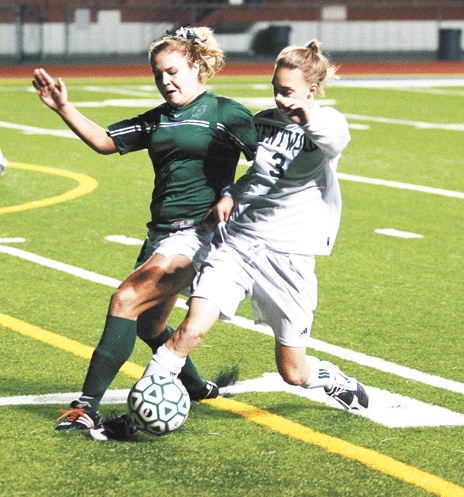 Beamer's Jessica Niewoehner (left) tries to steal the ball from Kentwood's Alex White during Wednesday night's game. Kentwood knocked off Beamer and now will play Gig Harbor on Saturday at Bethel High for a state berth.