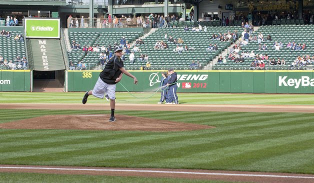 Covington's Spencer Johnson delivers the first pitch before last Saturday's Mariners-Twins game at Safeco Field.
