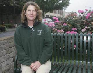 City of Kent maintenance worker Janet Henderson keeps Kent blooming. She shown Sept. 19 sitting near some of the city's downtown landscaping.