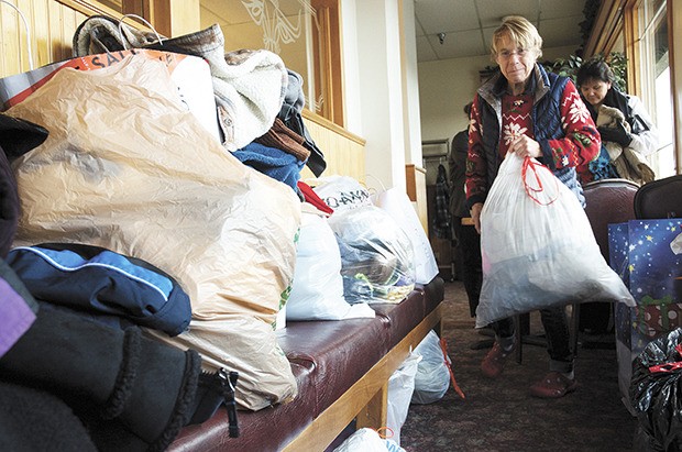 Andrea Torres finds a place for a bag of donated comfort goods during the recent Willow’s Place coat drive at the Golden Steer Steak & Rib House. The restaurant hosted a Dec. 5 Hope for Families luncheon to raise support and collect donations for Willow’s Place