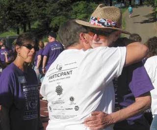 Darryl Tapp gets a hug May 26 during the Kent Relay for Life at French Field. The relay was Tapp's first as a cancer survivor.