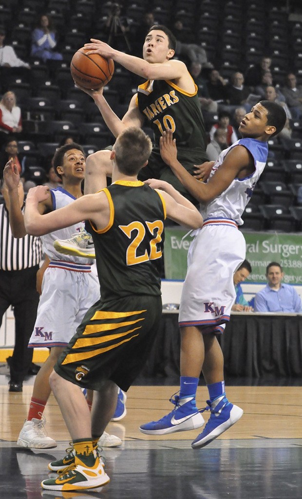 Kentridge's Matt Mcvicker goes up for a shot against the Kent-Meridian defense during the Les Schwab Kent Shootout on Thursday night.