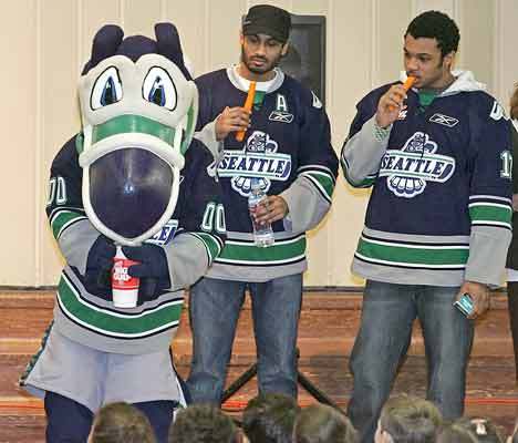 Seattle Thunderbirds Cool Bird demonstrates a bad choice in refreshments with his pop as his teammates Prab Ria