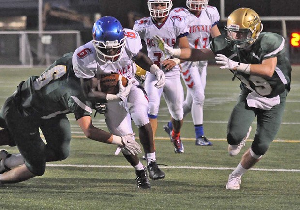 Shamar Malik Woolery blasts up the middle to score one of his four touchdowns for Kent-Meridian on Friday night.