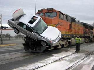 A car that fell off a semi-truck carrying new vehicles became impaled on a freight-train engine after the train struck the stopped truck Jan. 30 along South 212th Street in Kent.