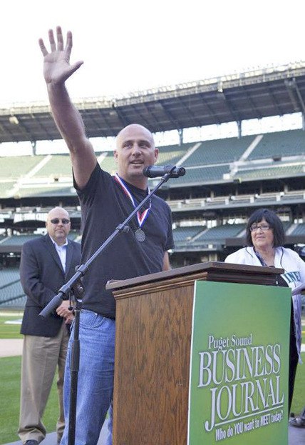 Dynamic Partners CEO Jon Botten accepts a best workplace award from the Puget Sound Business Journal at CenturyLink Field in Seattle.