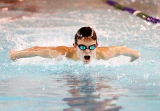 Creating his own wake: Kentridge’s Cameron Whiting parts the water during the 100 butterfly last week during a South Puget Sound League North Division dual against Auburn Riverside. Whiting won the event