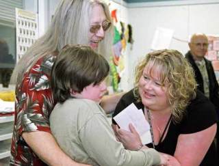 Kent’s Teacher of the Year Michelle Kelly shares a light moment with parent Perry Sobolik and his son Tommy during her award ceremony Wednesday at Kent Elmentary. Sobolik was one of the people who nominated Kelly for the honor.