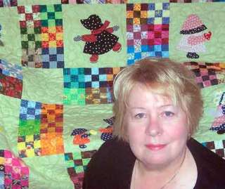 Quilter Mary Allen is  shown with one of her creations.