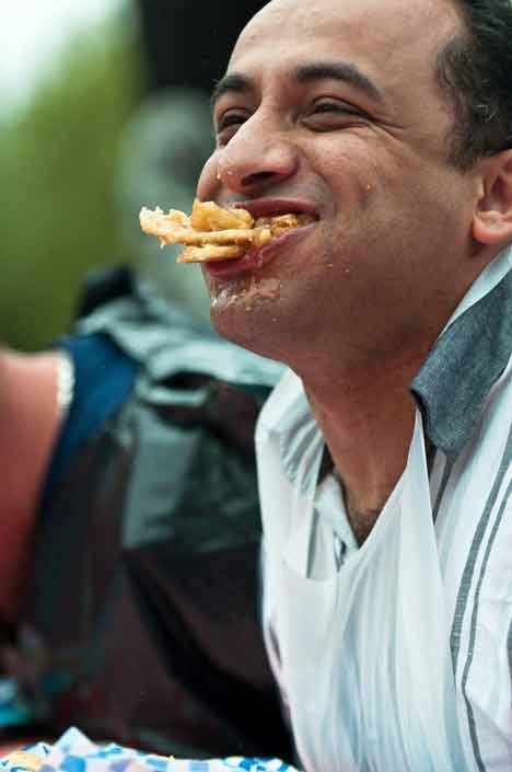 Sam Nageb of Kent cracks a smile during the 18 and older division of the Pie-Eating Contest at the Kent Fourth of July Splash.