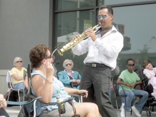 Darren Motamedy serenades Barbara Henderson Aug. 12 during a free Soulful Sounds of Summer concert at Kent Station. Motamedy and his band entertained the crowd with songs from his new album 'Don't Cha' Know.'