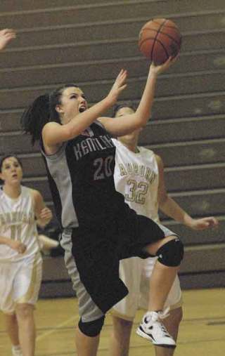 Big victory: Kentlake’s Brona Nienow goes hard to the basket during Friday night’s 43-35 win over the Trojans. The win helped the Falcons take a firm grasp of the SPSL North’s No. 5 seed to the playoffs.