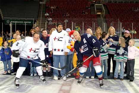 Participants in an earlier Thunderbirds Hockey Challenge line up for photographs on the ice. Even Ronald McDonald showed up for the fun. This year’s challenge is Feb. 27