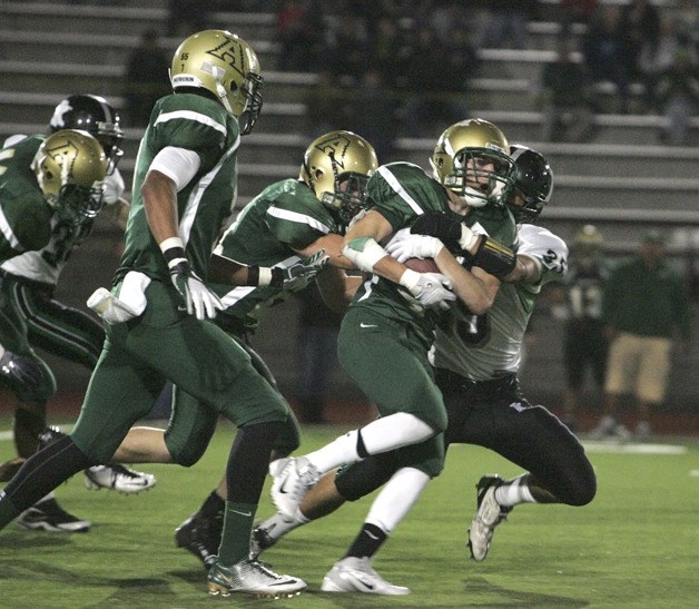 Auburn's Lincoln Burt holds on tight as Kentwood's Michael Oak takes him down