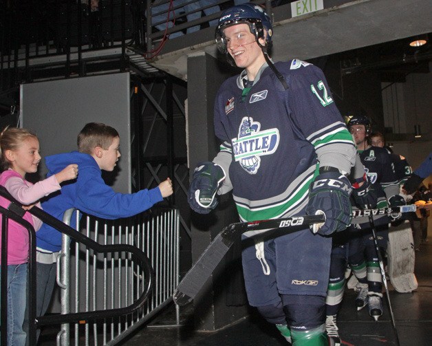 Seattle Thunderbird Tyler Alos greets fans as the team walks out to the ice