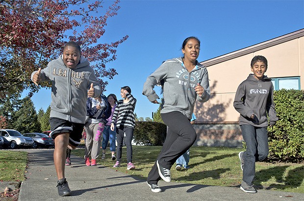 Sunrise Elementary students run around the school building as part of coach Ryan Kaufman’s improvisation to the unexpectedly high number of signups for his club.