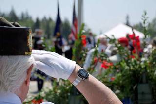A veteran salutes during Monday's Memorial Day services at Tahoma National Cemetery in Kent.