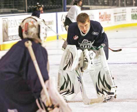 Thunderbirds goalie Calvin Pickard watch as a camper demonstrates his goal-keeping technique during the T-Birds' hockey-training camp July 21. Pickard has been selected to the U-18 Canada team.