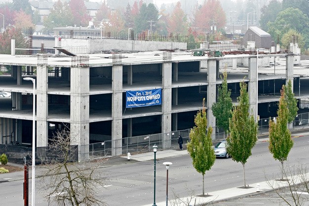 A Seattle developer plans to tear down the unfinished parking garage in downtown Kent in early October to build apartments and retail space.