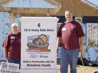 Kristen and Brian Bruhahn take a break to pose for a picture during a week spent in Dallas building a home for Habitat For Humanity. The couple said the week inspired them to get involved locally as well.