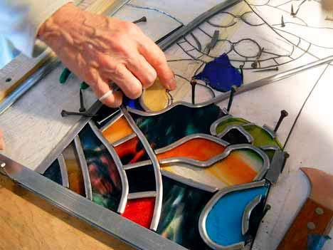 A volunteer assembles the many pieces of a segment for the stained-glass window at Kent Lutheran Church